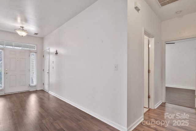 foyer with visible vents, baseboards, and wood finished floors