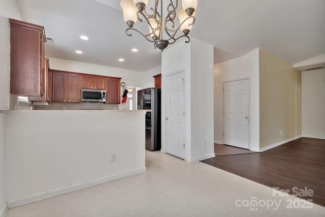 kitchen with recessed lighting, appliances with stainless steel finishes, baseboards, light floors, and a chandelier