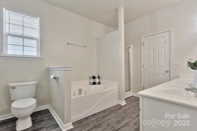 full bathroom with a shower stall, toilet, wood finished floors, a bath, and a sink