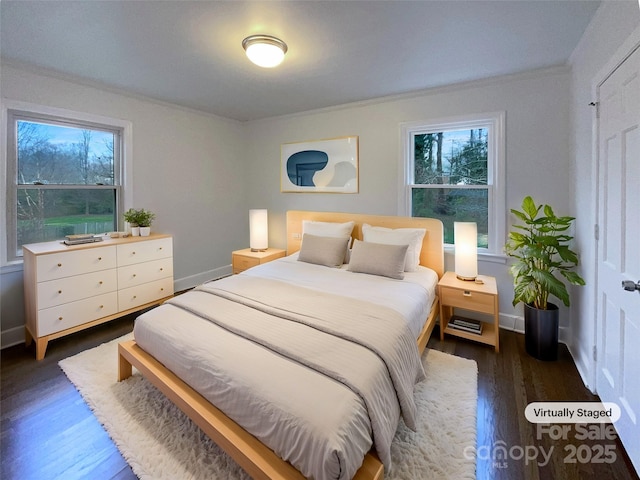 bedroom featuring crown molding, baseboards, and wood finished floors