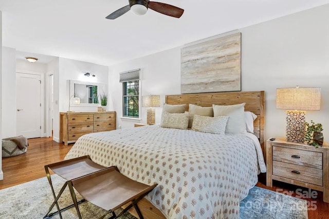 bedroom featuring baseboards, ceiling fan, and wood finished floors