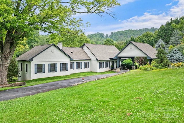 ranch-style house with a gazebo, a front lawn, and a chimney