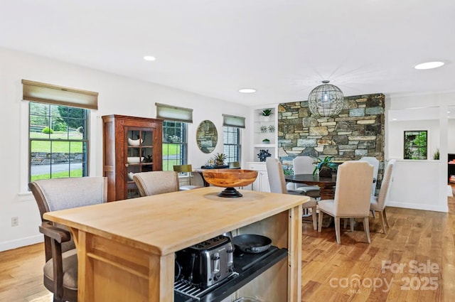 kitchen with recessed lighting, light wood-type flooring, and baseboards