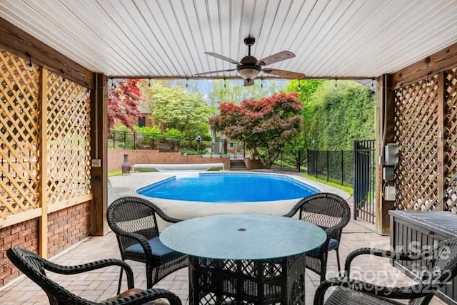 view of swimming pool with a fenced in pool, a patio, ceiling fan, and fence