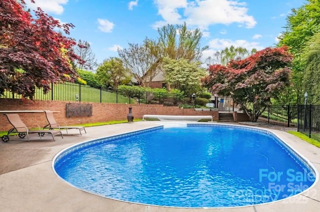 view of swimming pool with a fenced in pool, a patio area, and fence