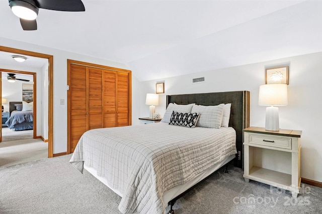 bedroom with visible vents, a closet, carpet flooring, baseboards, and ceiling fan