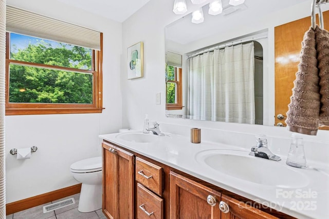 full bathroom with visible vents, plenty of natural light, and a sink