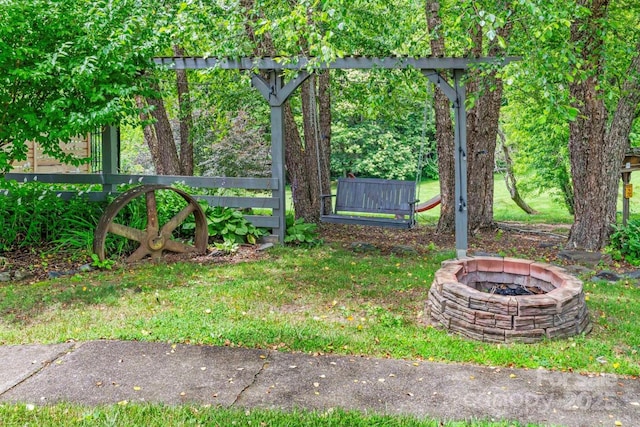 view of yard with a fire pit and fence