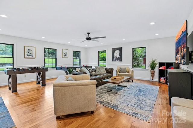 living area with recessed lighting, light wood-type flooring, baseboards, and a ceiling fan