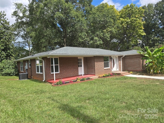 single story home with a front yard, central air condition unit, and brick siding