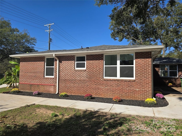 view of side of home with brick siding