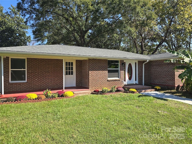 single story home featuring brick siding and a front lawn