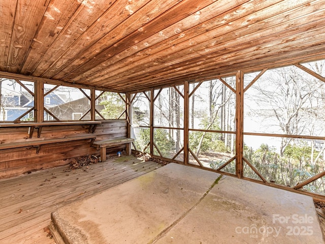 unfurnished sunroom with wood ceiling