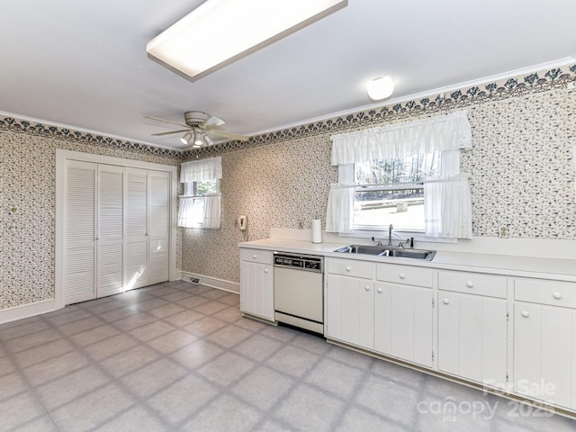 kitchen with wallpapered walls, white dishwasher, a sink, light countertops, and white cabinets