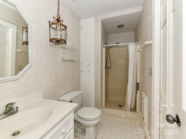 full bath with tile patterned flooring, vanity, a shower stall, and wallpapered walls