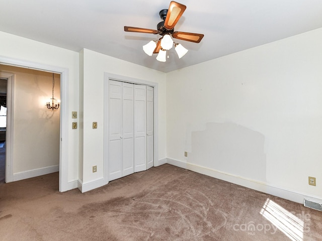 unfurnished bedroom with baseboards, visible vents, carpet floors, ceiling fan, and a closet