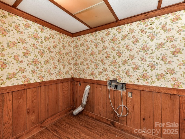 laundry area with wallpapered walls, laundry area, dark wood finished floors, and a wainscoted wall