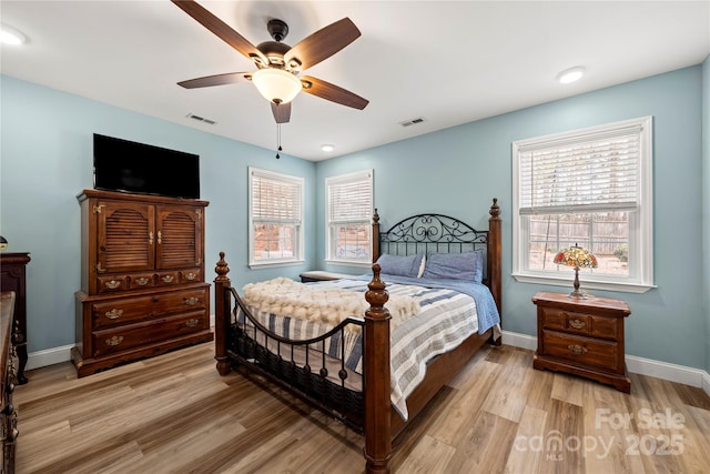 bedroom featuring visible vents, baseboards, and light wood-style floors