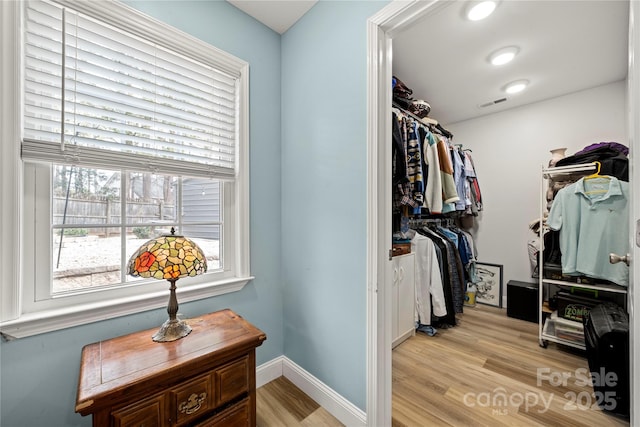 walk in closet with light wood-style floors and visible vents