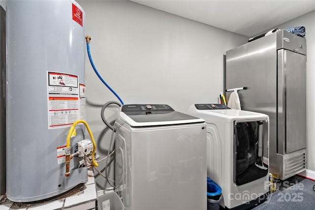 laundry room with gas water heater, washer and clothes dryer, and laundry area