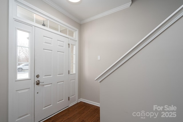 foyer featuring dark wood-style flooring, baseboards, and ornamental molding