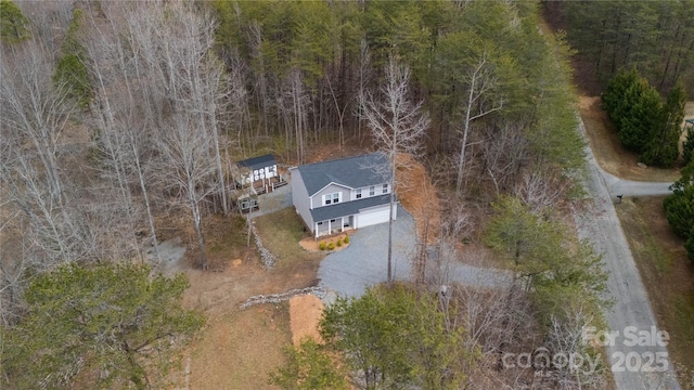 drone / aerial view featuring a forest view