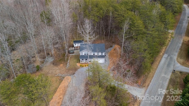 aerial view featuring a wooded view