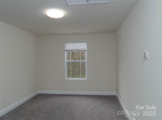 spare room with baseboards and carpet flooring