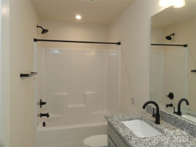 bathroom featuring toilet, vanity, and shower / bathing tub combination