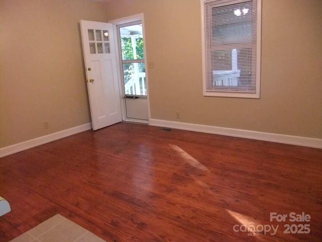 entryway featuring visible vents, baseboards, and dark wood-style flooring