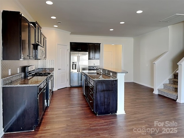 kitchen featuring a sink, dark wood-type flooring, light stone countertops, and stainless steel appliances