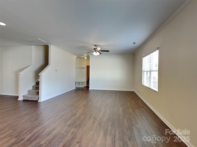 unfurnished living room featuring stairs, crown molding, dark wood finished floors, and baseboards