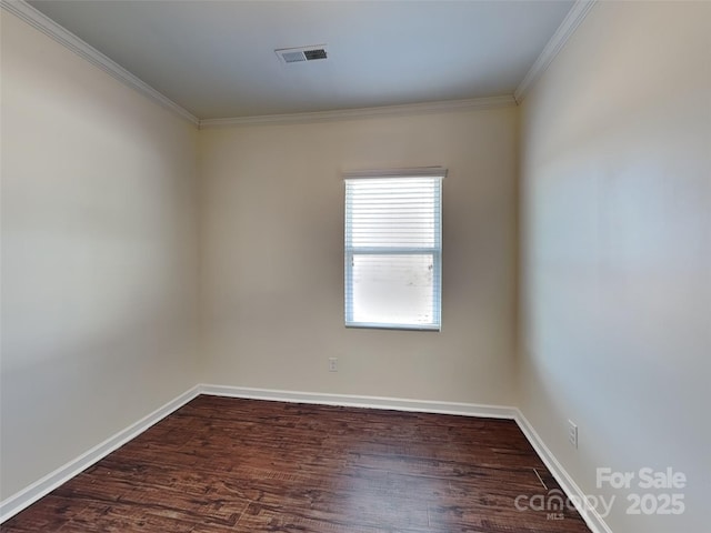 spare room featuring visible vents, baseboards, dark wood-style flooring, and crown molding