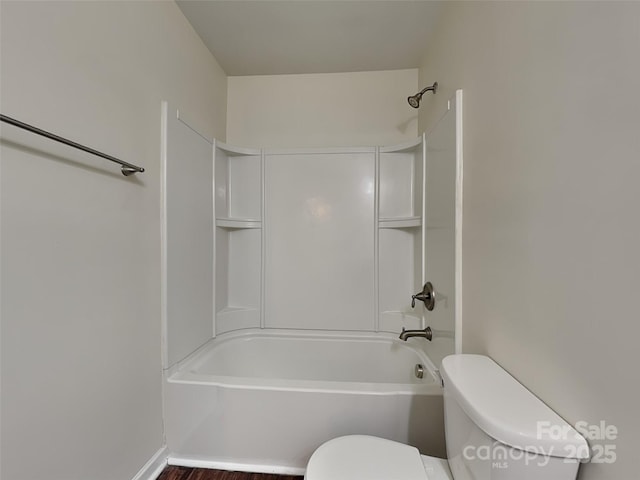 bathroom featuring shower / bathing tub combination and toilet