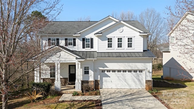 view of front facade featuring driveway, covered porch, stone siding, a garage, and metal roof