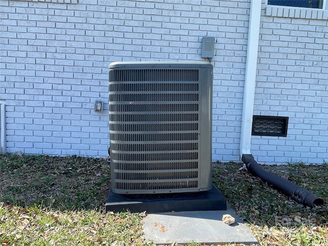 exterior details with brick siding and central AC