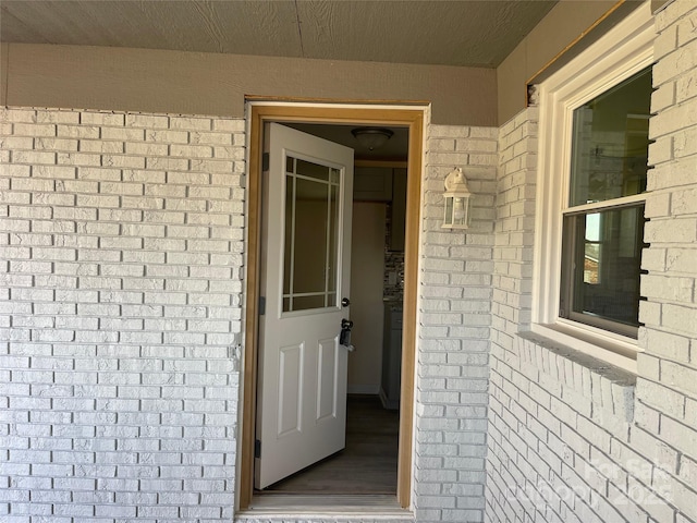 view of exterior entry with brick siding