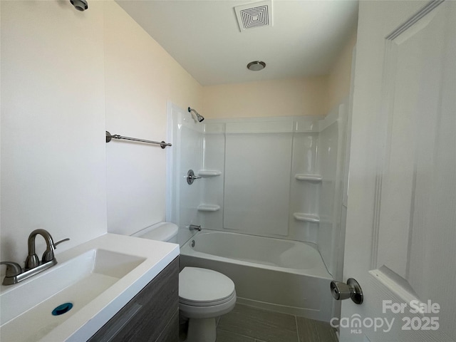 full bathroom featuring visible vents, toilet, vanity, and washtub / shower combination