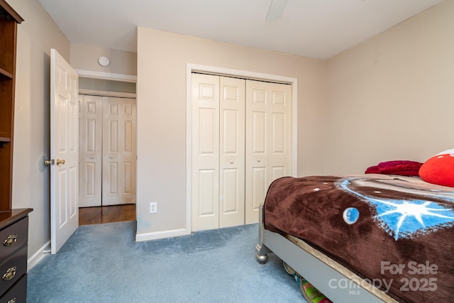 carpeted bedroom featuring a closet, baseboards, and a ceiling fan