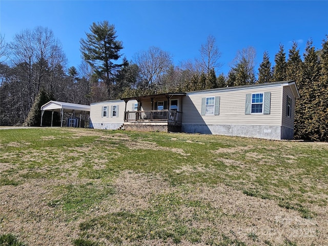 view of front of property with crawl space, a deck, a detached carport, and a front lawn