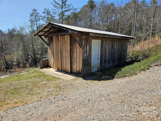 view of shed featuring a forest view