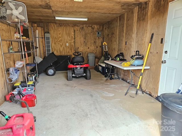 garage featuring wood walls