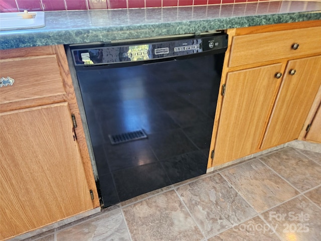 room details featuring dark countertops and black dishwasher