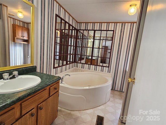 bathroom with visible vents, wallpapered walls, a garden tub, tile patterned floors, and vanity