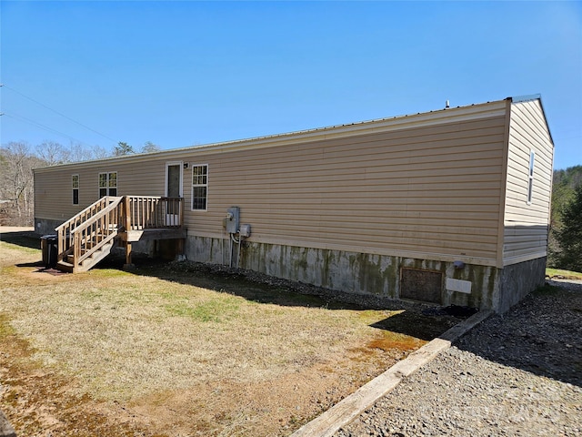 back of property featuring a lawn