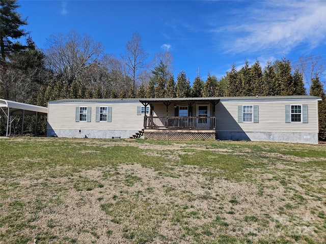 manufactured / mobile home with crawl space, a deck, and a front yard