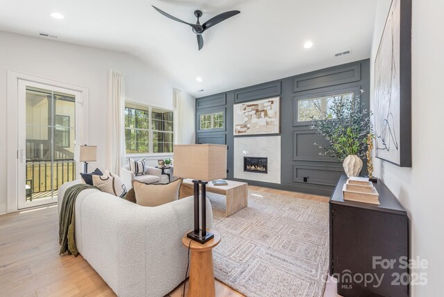 2021 S St, Charlotte, NC 28208 - living room with ceiling fan, a tile fireplace, vaulted ceiling, light wood finished floors, and recessed lighting