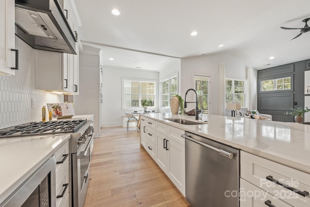 2021 S St, Charlotte, NC 28208 - kitchen featuring stainless steel appliances, a sink, custom range hood, light wood-style flooring, and white cabinets