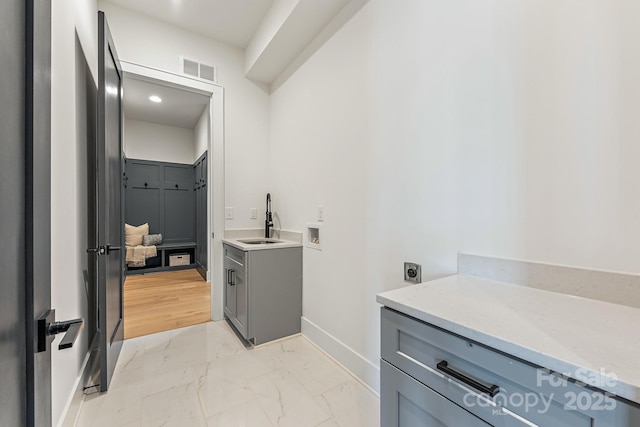 2021 S St, Charlotte, NC 28208 - laundry room featuring washer hookup, light marble finish flooring, baseboards, hookup for an electric dryer, and cabinet space