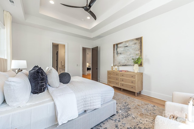 2021 S St, Charlotte, NC 28208 - bedroom with wood finished floors, a raised ceiling, recessed lighting, baseboards, and ensuite bathroom